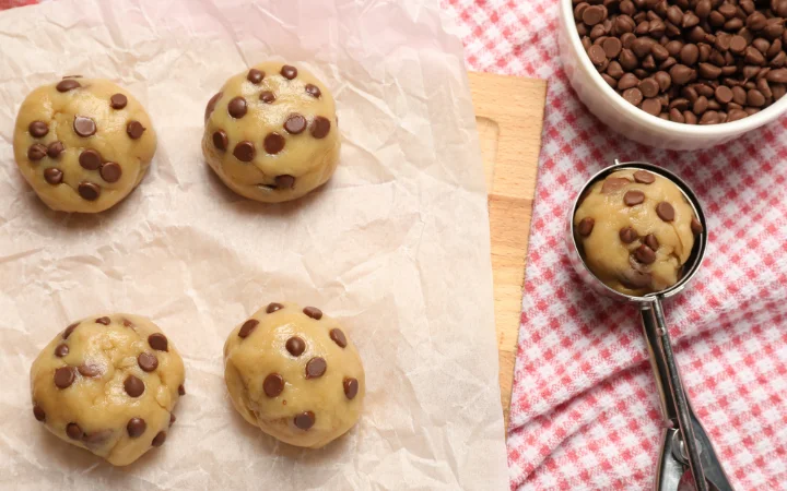  A kitchen scene where Ghirardelli chocolate chips are being used in various baking processes, emphasizing their role in creating premium baked goods.