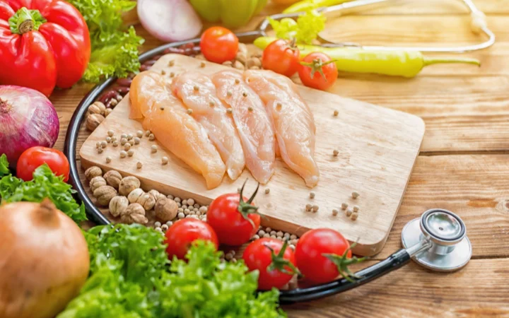 A bright and organized kitchen counter displaying key ingredients for a healthier Chicken Gnocchi Soup, including lean chicken breasts, whole grain gnocchi, fresh vegetables, and healthy alternatives like low-fat milk.