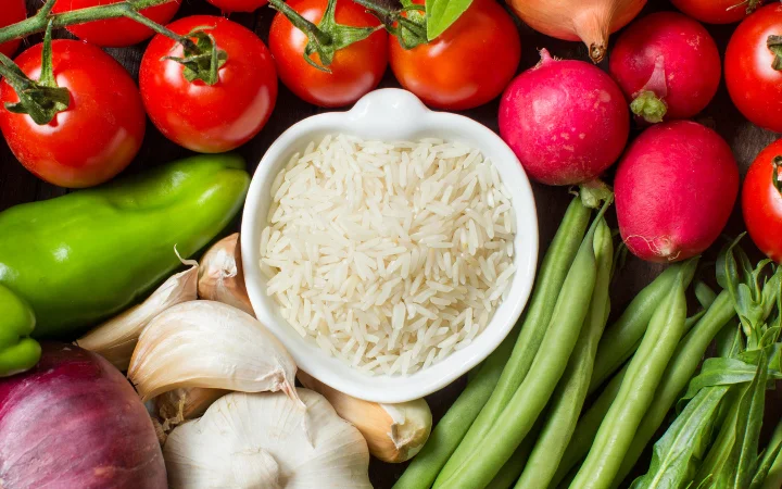 A vibrant display of key soup ingredients like carrots, rice, onions, and potatoes, with annotations highlighting their nutritional benefits.