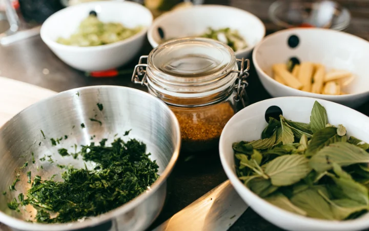 various bowls and herbs, representing the preparations for cooking with chimichurri seasoning 