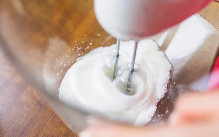 Crop person mixing ingredients with mixer