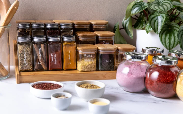 A creative culinary setup illustrating advanced soup flavor enhancers: mushrooms, sun-dried tomatoes, Parmesan rind, lemon, vinegar, and small bottles of soy and fish sauce, subtly suggesting the concept of umami and acidic components in cooking.