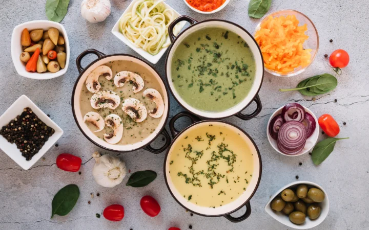 A creative kitchen setup showing various bowls of Chicken Gnocchi Soup, each representing different variations and substitutions, like vegetarian, gluten-free, and dairy-free versions, showcasing culinary creativity