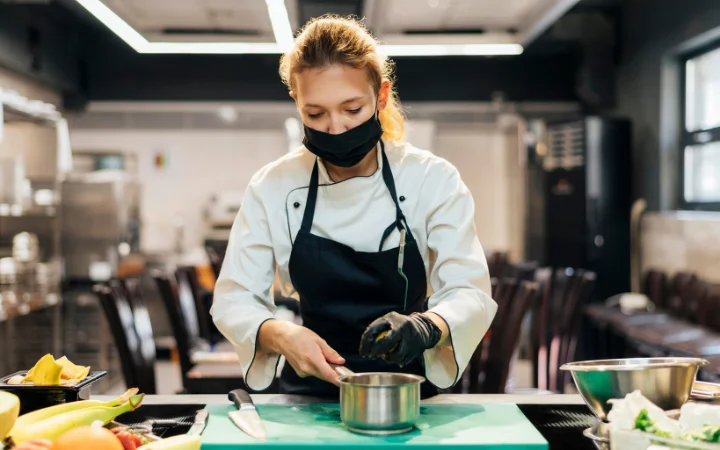 A gathering of professional chefs discussing over a pot of gnocchi soup, each chef representing a different culinary perspective. The image should convey a sense of expertise and the value of professional insights in perfecting gnocchi soup recipes.