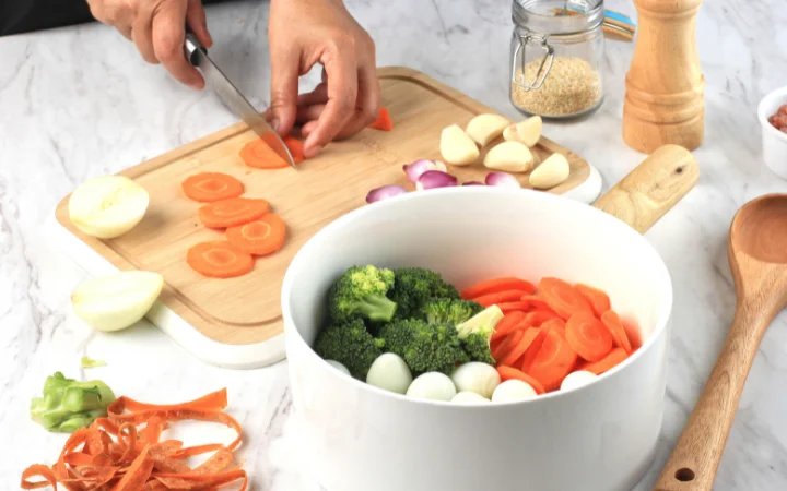 home chef tasting and seasoning vegetable soup, focus on flavor balance --culinary skills, cooking process