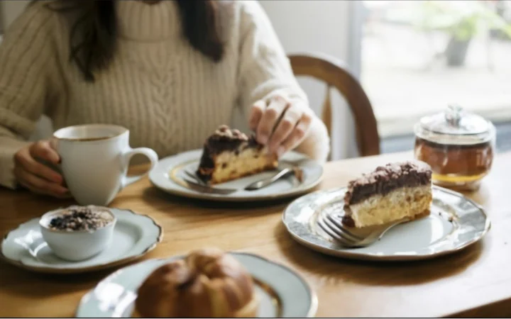 A heartwarming scene of a family enjoying coffee together at a dining table, with smiles and a sense of togetherness.