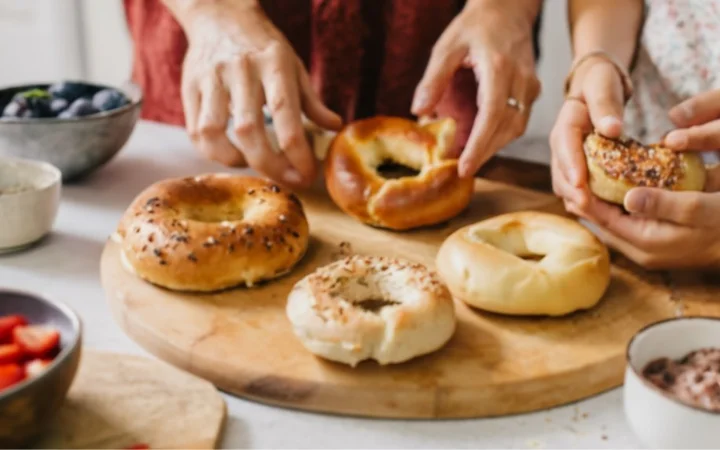 close up scene of family enjoying homemade baking showcasing hands having it in sunny kitchen, variety of toppings and spreads on table, joy of baking and healthy eating