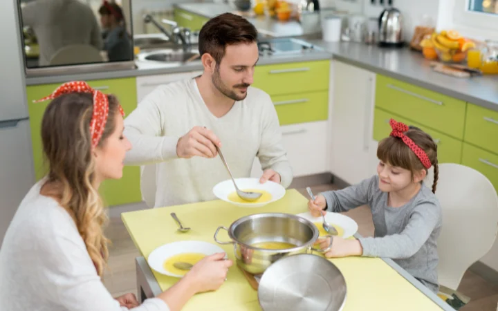 A comforting dining room setting with a Q&A board displaying frequently asked questions about Chicken Gnocchi Soup in a crockpot, with a family enjoying the soup in the background, symbolizing a satisfying conclusion to the culinary journey.