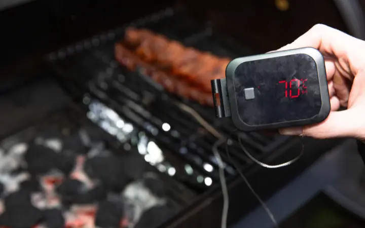 A kitchen setting with a digital display of various sous vide machines set at different temperatures for cooking corned beef, highlighting the importance of temperature precision.