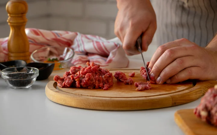 A culinary tutorial scene, illustrating the process of cooking corned beef, with emphasis on sautéing onions and garlic, and tips on enhancing flavors and textures.