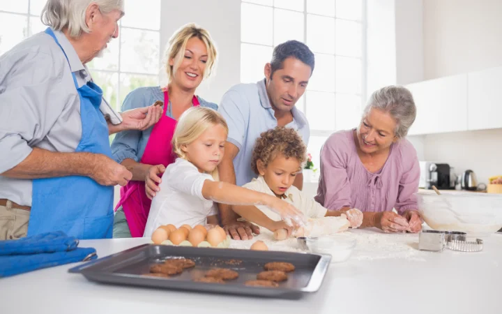 A heartwarming family scene where multiple generations are gathered in the kitchen, sharing laughter and stories while baking cookies together.