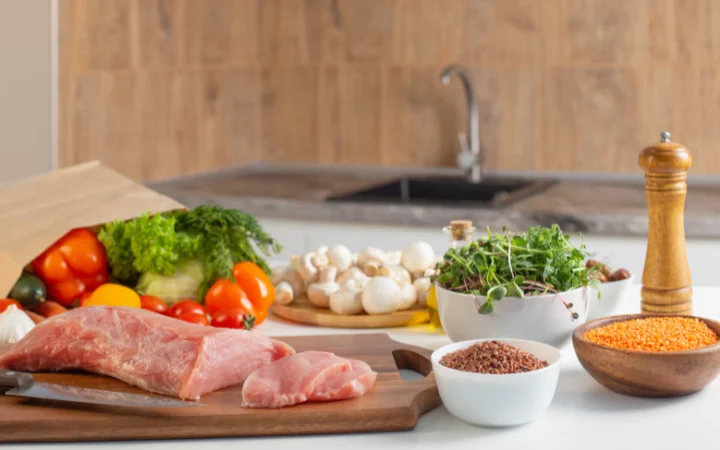 An engaging kitchen scene showing different cuts of corned beef (flat and point cuts) on a cutting board, with ingredients for brining like spices, salt, and water around.