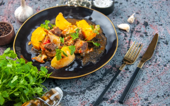 A beautifully arranged dinner plate showcasing corned beef accompanied by classic side dishes: boiled potatoes, steamed carrots, and cabbage, with a side of roasted root vegetables like parsnips and sweet potatoes, adding a colorful and healthy twist.