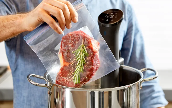 A visual of corned beef cooking in progress, with the vacuum-sealed bag submerged in a precisely controlled water bath, highlighting the slow cooking technique.