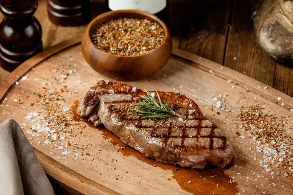 A rustic scene depicting the traditional process of curing corned beef with large grains of salt, set in a historical Irish setting.