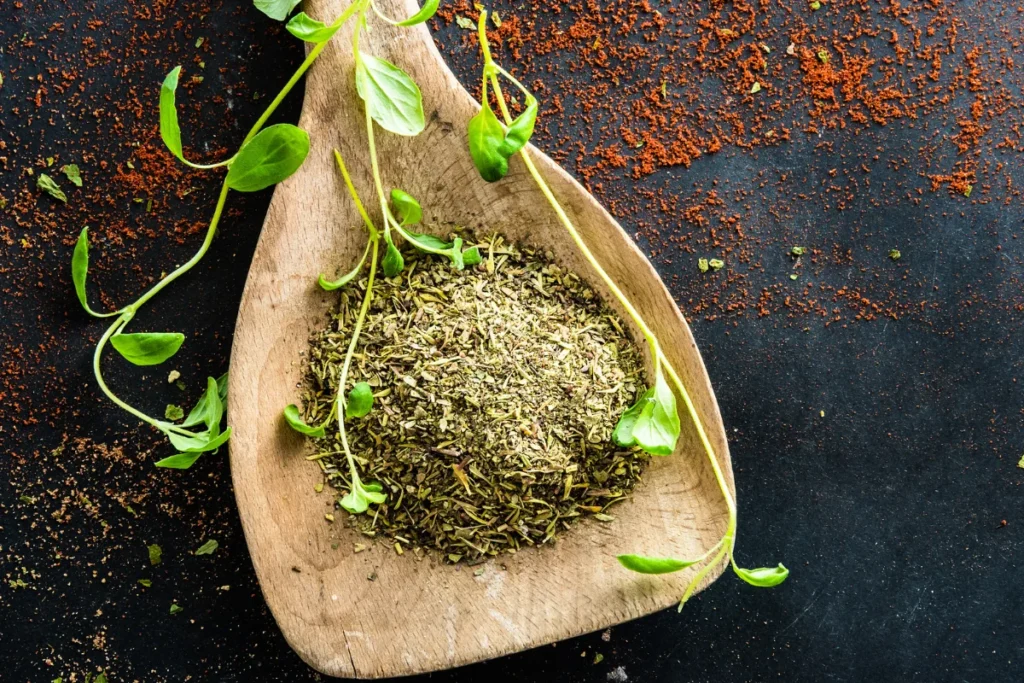 A vibrant display of fresh chimichurri sauce in a bowl, surrounded by its key ingredients like parsley, garlic, and olive oil.