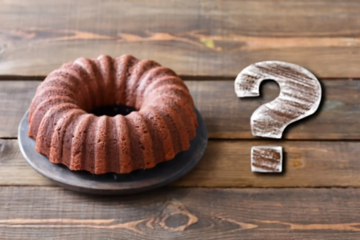 A rich and indulgent dessert on a wooden table, with a question mark symbol hovering above it, symbolizing the query about its storage.