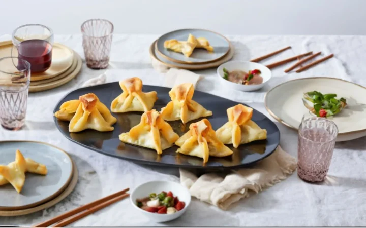 elegant dining table with Baked Crab Rangoon platter, complementary dishes