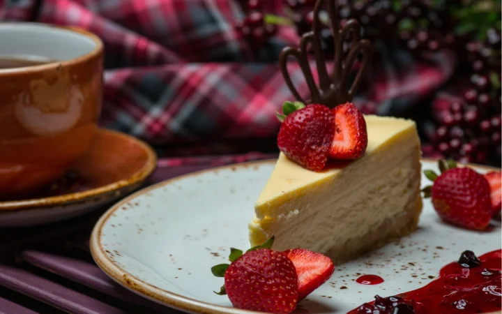 Vanilla cheesecake slice with strawberries, showcasing healthy versions