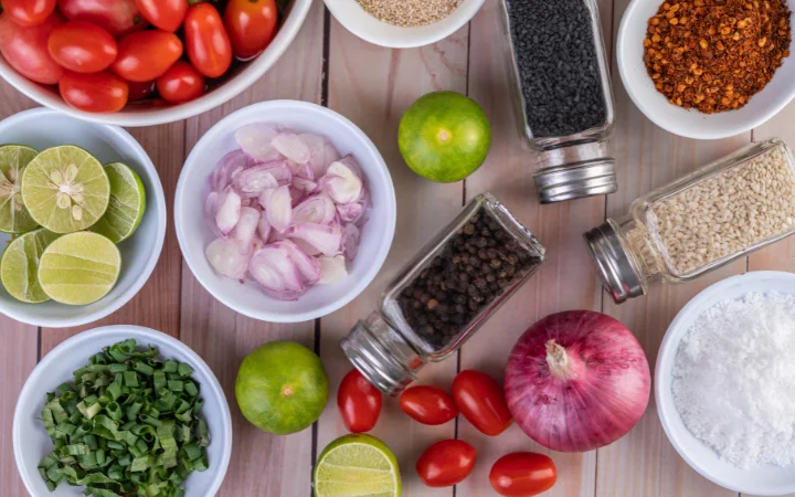 union cut into pieces in a white dish on a wooden tablewith other ingredients ready to cook with .