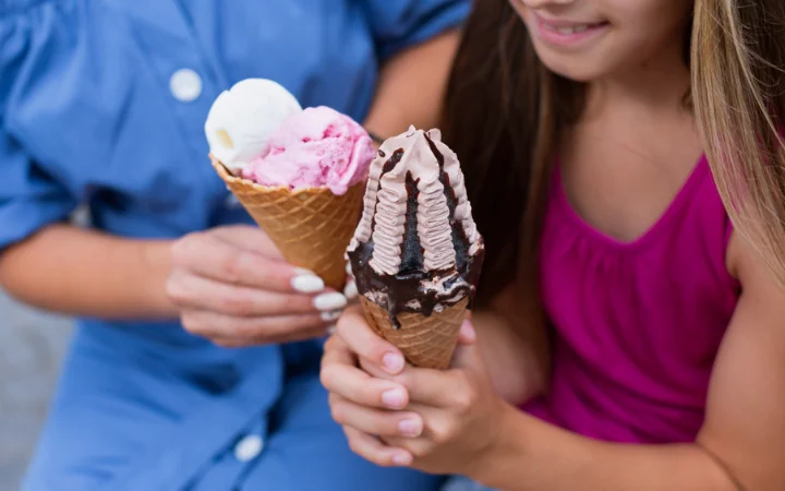 female hands holding fresh and delecious ice cream cones, 